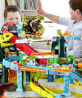 Father and son playing with Awesome Toy Car Ramp Track With Dinosaur Spray Hills Adventure Railcar Slot Car Race Set