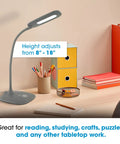 Gray Soft Touch LED Desk Lamp With 3 Brightness Levels And 450 Lumens on a desk with books and pencils, height adjusts 8-18 inches.