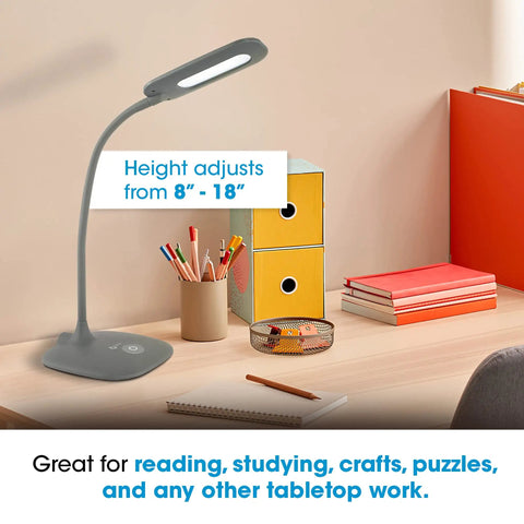 Gray Soft Touch LED Desk Lamp With 3 Brightness Levels And 450 Lumens on a desk with books and pencils, height adjusts 8-18 inches.