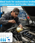 Mechanic using Pro Grade Brake Bleeder Kit For Cars And Motorcycles With 22 Inch Clear Hose 12 Adapters visible with vehicle engine.