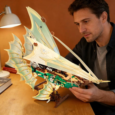 Transparent Wing Phantom Starship Build Kit Dope Futuristic Mechanical Design Steampunk Sci Fi Style Model Realistic Flying Look Durable Internal Skeleton Frame Creative Building Block Toy For Builders And Collectors assembled next to man at desk
