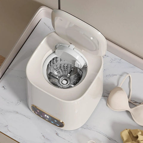 Portable Fully Automatic Washing Machine With LCD Touchscreen Auto Cycle One Click Operation No Sweat Cleanup For Dorms Apartments And RV Travel 9L Compact Washer with open lid and silver drum, on marble surface.