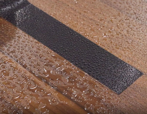 Close-up of Heavy Duty Wide Duct Tape 3 Inch By 55 Yards Waterproof All Weather Industrial Strength Tape on wet surface