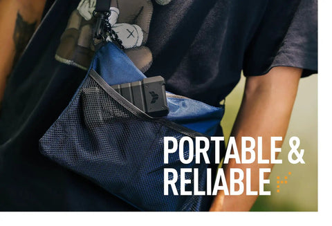 TUF Gaming A2 USB C 3.2 Gen 2x2 Portable SSD Enclosure with Dual M2 NVMe PCIe and SATA shown in a mesh bag outdoors.