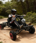 Person riding Powerful 2000W Electric Go Kart For Adults And Kids With 25 MPH Top Speed For A Thrill Ride on a dirt path
