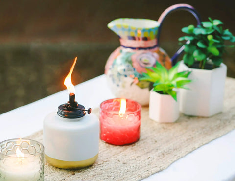 Adjustable Flame Glass Votive Table Top Torch For Outdoor Yard Patio And Deck, Refillable Flame Control, 6.75 Inch displayed on table.