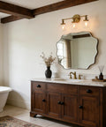 Bathroom with Three Light Antique Brass Wall Sconces with Clear Glass Globes Dope Industrial Vanity Lighting