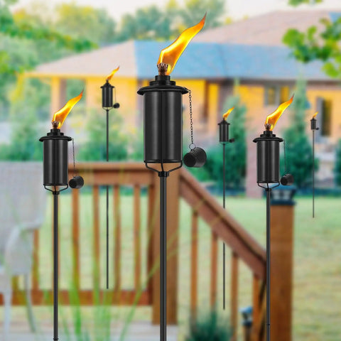 Outdoor Metal Torch Set Of Six, 16 Oz Citronella Torches With 59 Inch Adjustable Height shown in a garden setting