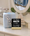 Wooden desk sign reading 'A Day Without Math' on a dresser with holiday decor, Funny Math Teacher Gift For Classroom Nerds Women And Men Desk Wood Sign A Day Without Math Must Have Office Decor Great Gift For Teachers And Classroom Decor Enthusiasts For Desk Or Wall Display.