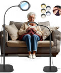 Elderly woman using 12X Lighted Floor Magnifier With Flexible Gooseneck Clamp Stand For Hands Free Close Work Sewing Reading Crafting And Repairs, 5 Color Modes With 10 Adjustable Brightness Levels, 5.2 Inch Lens for knitting on sofa