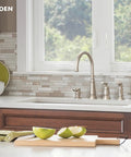 Edison One-Handle High Arc Kitchen Faucet With Side Sprayer And Soap Dispenser, 4-Hole Mount in a modern kitchen setup