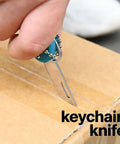 Close-up of 7-In-1 EDC Pocket Knife Multitool for Keychain Quick Fixes, Outdoor Gear, and Daily Tasks in use slicing a box.