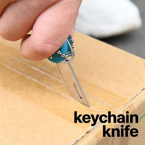 Close-up of 7-In-1 EDC Pocket Knife Multitool for Keychain Quick Fixes, Outdoor Gear, and Daily Tasks in use slicing a box.