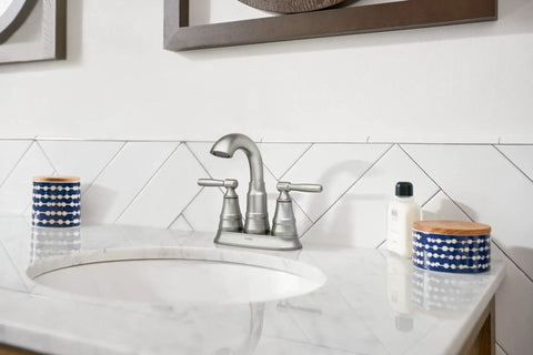 Spot Resist Brushed Nickel Two Handle Centerset Bathroom Sink Faucet With Drain Assembly installed on marble countertop