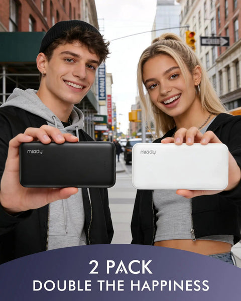 Two young adults holding a black and white Slim Two Pack Portable Charger And 10000 Mah Power Bank For Travel, ready to charge gadgets.