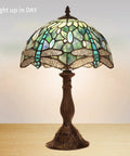 Dragonfly Tiffany Style Table Lamp With Stained Glass Shade, Bronze Base, 18 Inch Tall Bedside And Desk Light, Handmade Glass Lampshade, LED Bulb Included, Warm White 2700K, E26 Base, Ideal Living Room Or Bedroom Decor displayed lit up on wooden table