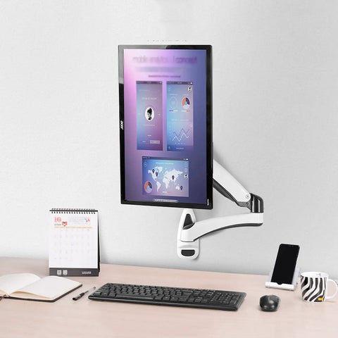 Desk Clearing Wall Mount Monitor Arm With Butter Smooth Mechanical Spring Adjustment Fits 12 To 27 Inch Screens mounted beside desk.