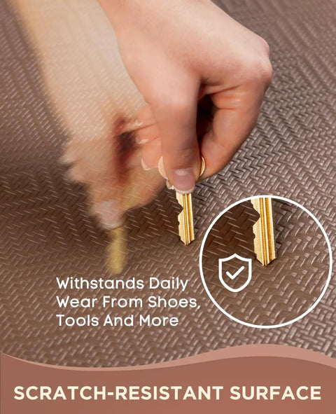 Close-up of a person holding a key showing the scratch-resistant surface of an Anti Fatigue Kitchen Mat 0.75 Inch Thick Cushioned 20x39 Inch Waterproof Non Slip Ergonomic Standing Rug For Kitchen, Office, And Sink Brown Super Comfy For Long Shifts