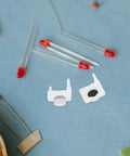 Close-up of 40 Piece Silicone Push Button Switch Replacement Keypad Membrane For Home Diy Repair, durable white silicone switches on a blue background.