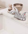 Two Handle Bathroom Sink Faucet With WaterSense Certification In Polished Chrome Slick Curved Design Easy Upgrade For Any Vanity 1.2 GPM Low Flow Modern Look, installed on a bathroom counter