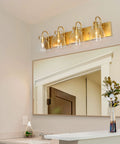 Gold Vanity Light Fixture With Clear Glass Shades, Four Light Over Mirror Bathroom Lighting in elegant spa-worthy bathroom