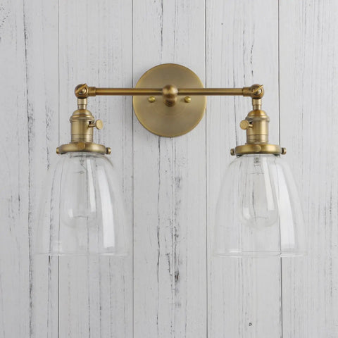 Double Sconce Wall Light Set Vintage Industrial Antique Vibe With Two Oval Cone Clear Glass Shades mounted on white wall