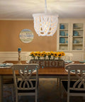 Wood Beaded Farmhouse Chandelier With White Finish And Adjustable Cord over dining table in rustic style room.