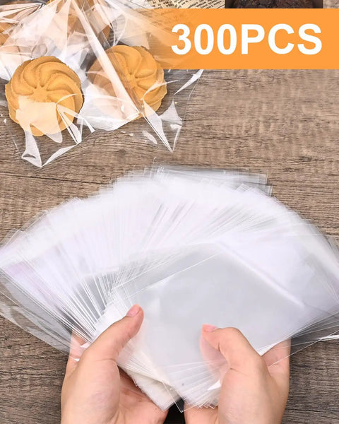 Hands holding 300 Pack Self Adhesive Cookie Bags 4x6 Inch Clear Cellophane Bags with Easy Seal Resealable Packaging for treats