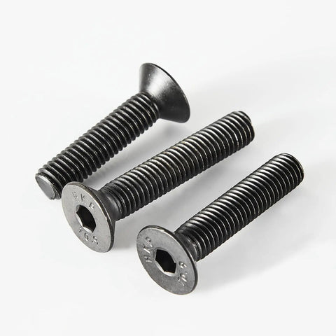 Close-up of three Beefy M3 Flat Head Hex Socket Screws Kit 125 Pieces Black Oxide 10.9 Grade Alloy Steel Fully Threaded Countersunk Bolts