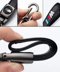 Close-up of BMW M Keyring with black leather strap and metal hook, featuring the iconic M logo.