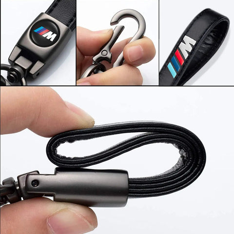 Close-up of BMW M Keyring with black leather strap and metal hook, featuring the iconic M logo.