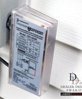 CD1-024R Compressor Defender installed on wall near AC unit, clear casing and labeled instructions visible, protects from surges and brownouts.