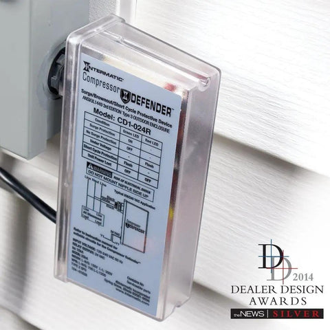 CD1-024R Compressor Defender installed on wall near AC unit, clear casing and labeled instructions visible, protects from surges and brownouts.