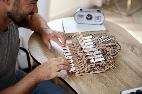 Mechanical Celesta Wooden Puzzle Kit For Adults, 3D DIY Musical Instrument That Doubles As A Functional Mini Piano, Music Box And Xylophone Brain Teaser, 4.7 Inch Tall Wood Model, on table