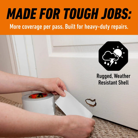 Person applying heavy duty and weather resistant white wide duct tape for indoor and outdoor use on a damaged door surface.