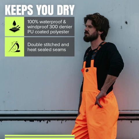 Man wearing Hi Viz Ripstop Waterproof Bib Pants For Men With Reflective Safety Strips, High Visibility Orange, showing waterproof label
