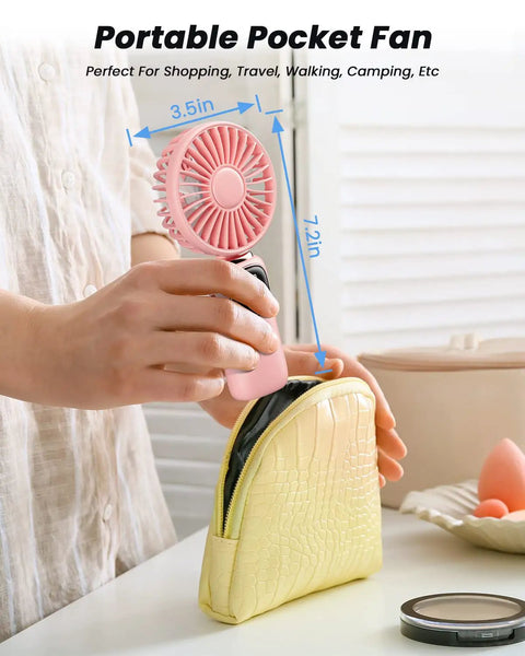 Person placing 3 In 1 Portable Personal Fan With 4000mAh Battery And LED Display into yellow pouch, showing fan's compact size