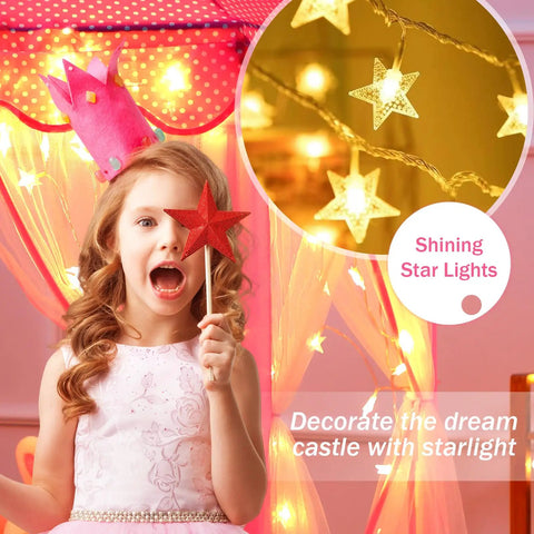 Girl with red star wand inside Princess Castle Tent For Girls With Star Lights Large Indoor Outdoor Playhouse Private Hideaway For Kids 55 Inch By 53 Inch Castle Style Toy Tent Fairy Tale Bedroom Play Space For Imaginary Adventures Totally Magical, surrounded by glowing star lights.
