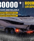 12V Submersible LED Trailer Light Kit with 7 Functions illuminating a trailer in rain, IP68 rated for marine use