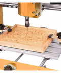 Two Piece CNC T Slot Hold Down Clamp Kit With Adjustable Pivot And Height shown securing wood on a CNC router platform