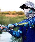 Person fishing wearing Sol Armis UPF 50 Boonie Hat For Men And Women, Breathable Sun Protection Hat With Mesh Vents, Prym1 Turquoise Fade