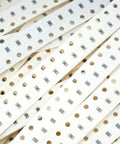 SMD resistor strips on white perforated carrier tape with 1206 resistors for PCB assembly