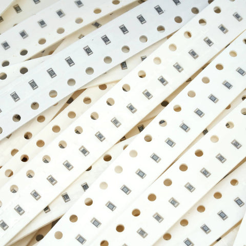 SMD resistor strips on white perforated carrier tape with 1206 resistors for PCB assembly