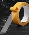 Ultra Thin Clear Double Sided Tape 1.18 Inch By 66 Feet Versatile Mounting Tape, transparent strip on dark marble surface