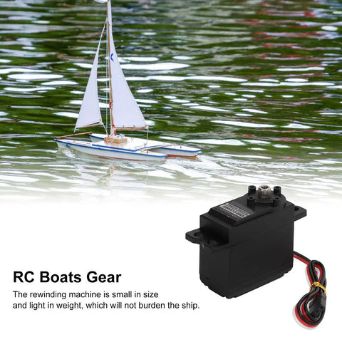 Beefy Metal Gear Sail Winch Servo Motor With Alloy Gears Analog Servo for Ship Rope Rewind next to a model sailboat on water