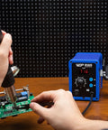 Hot Air Rework Soldering Station With Temperature Control And Adjustable Air Flow, Digital Display For SMD Soldering, Fast Heat Up, PID Stabilization, Includes Four Extra Nozzles For Precise Rework being used on a circuit board