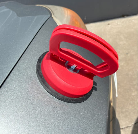 Double Handle Car Dent Lifter With Locking Suction Plate 4 Inch Diameter Vacuum Dent Puller on a car hood