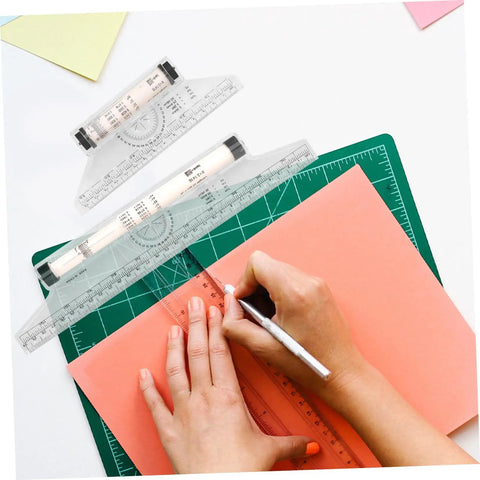 Badass Transparent Rolling Ruler And Drafting Kit For Slick Parallel Lines Precise Protractor Angles Smooth Arc Tracing Multi Function Layout Tool 2 Pack For Creators being used to trace on orange paper.