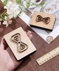 Leather Cutting Die Set 2 Piece 2 Styles With Wooden Die Molds Sharp Steel Blades Wallet Punching Dies And DIY Craft Stamping Tool On Smooth Wooden Base displayed on a table with a ruler and flowers