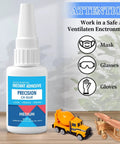 Bottle of Pro Grade Medium CA Glue For Metal And Stone Quick Dry Adhesive with toy construction vehicles and safety instructions.